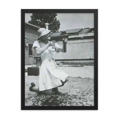 Nurse with an M-3 Grease Gun, WWII 1940s framed print on a plain backdrop in size 18"x24".