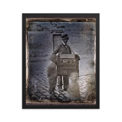 Organ Grinder on the Street with Children, c. 1848 framed print on a plain backdrop in size 16"x20".