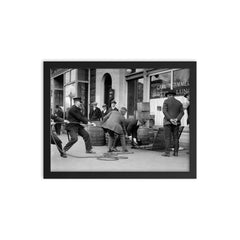 Police seizing bootleg liquor - Police haul barrels of illegal liquor from the basement of a speakeasy during the era of alcohol prohibition, 1923 framed print on a plain backdrop in size 12"x16".