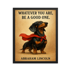 proud dachshund in superhero cape with lincoln quote whatever you are be a good one inspiring poste framed print on a plain backdrop in size 16"x20".