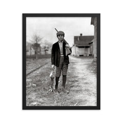 Rabbit Hunting - A boy returns home from rabbit hunting, Dillon, South Carolina, 1909 framed print on a plain backdrop in size 16"x20".