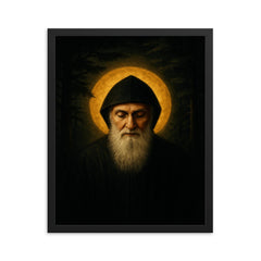Saint Charbel in cedar darkness and gold light framed print on a plain backdrop in size 16"x20".