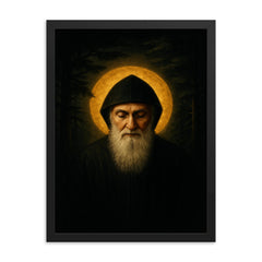 Saint Charbel in cedar darkness and gold light framed print on a plain backdrop in size 18"x24".