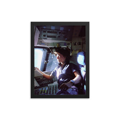 Sally Ride on the Flight Deck, 1983 framed print on a plain backdrop in size 12"x16".