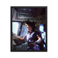 Sally Ride on the Flight Deck, 1983 framed print on a plain backdrop in size 16"x20".