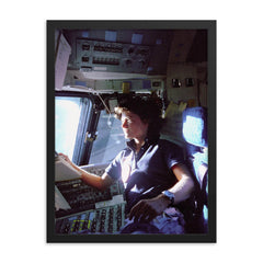 Sally Ride on the Flight Deck, 1983 framed print on a plain backdrop in size 18"x24".