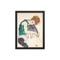 Seated Woman with Bent Knee by Egon Schiele framed print on a plain backdrop in size 12"x16".