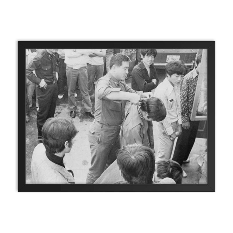 South Korean Soldier Cutting Hair During 1970s Crackdown framed print on a plain backdrop in size 18