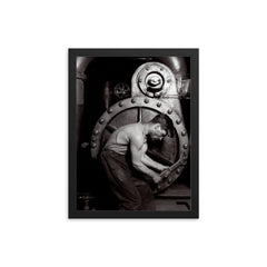 The Steamfitter, 1921 - Lewis Hines' iconic black and white photo of a power plant mechanic posed in front of a steam generator framed print on a plain backdrop in size 12"x16".