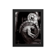 The Steamfitter, 1921 - Lewis Hines' iconic black and white photo of a power plant mechanic posed in front of a steam generator framed print on a plain backdrop in size 8"x10".