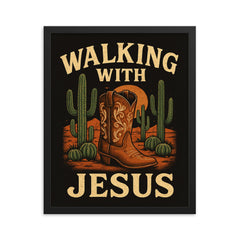 The words 'Walking with Jesus' with a cowgirl aesthetic inspired design of desert cacti and cowgirl boots framed print on a plain backdrop in size 16"x20".