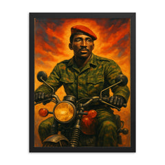Thomas Sankara on motorcycle in fatigues framed print on a plain backdrop in size 18"x24".