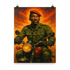 Thomas Sankara on motorcycle in fatigues poster on a plain backdrop in size 8"x10".