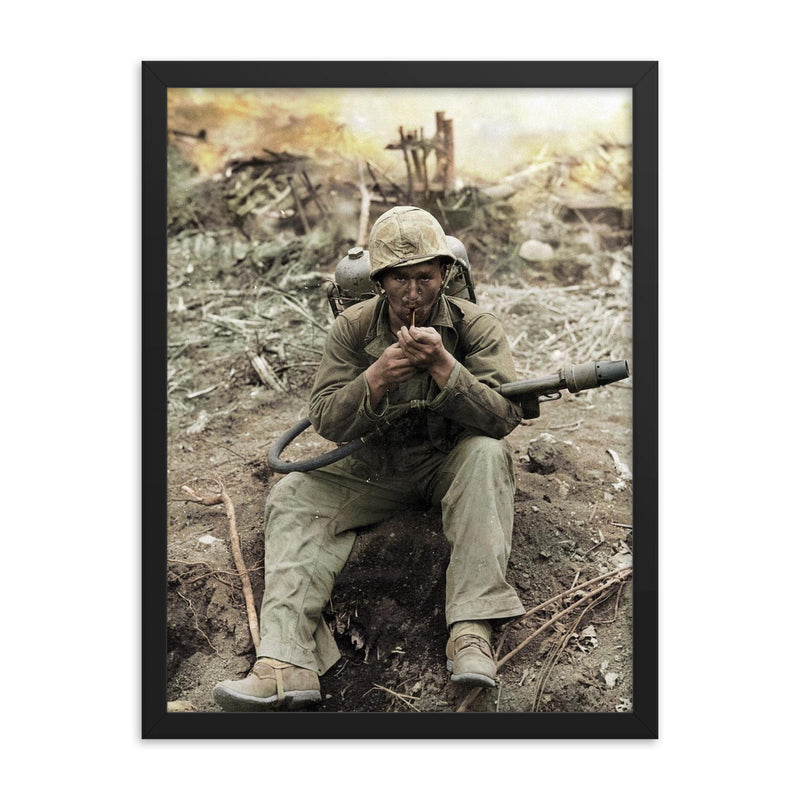 US Marine with M2-2 Flamethrower Lighting a Pipe, Iwo Jima in Background framed print on a plain backdrop in size 18