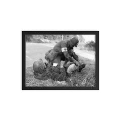 US Medic Providing First Aid to Wounded German Soldier, France 1944 framed print on a plain backdrop in size 12"x16".