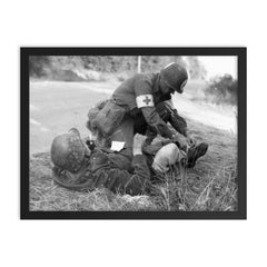 US Medic Providing First Aid to Wounded German Soldier, France 1944 framed print on a plain backdrop in size 18"x24".