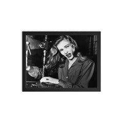 Veronica Lake Demonstrating the Risks of Long Hair for Women War Workers, November 9, 1943 framed print on a plain backdrop in size 12"x16".