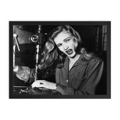 Veronica Lake Demonstrating the Risks of Long Hair for Women War Workers, November 9, 1943 framed print on a plain backdrop in size 18"x24".
