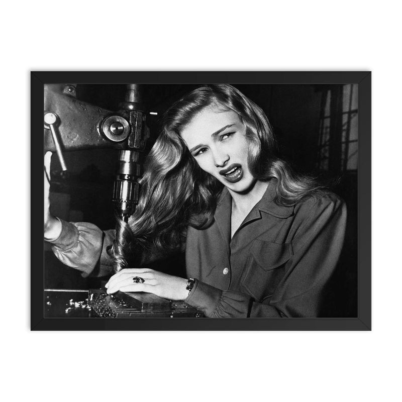 Veronica Lake Demonstrating the Risks of Long Hair for Women War Workers, November 9, 1943 framed print on a plain backdrop in size 18