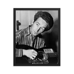 Woody Guthrie framed print on a plain backdrop in size 16"x20".