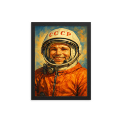 Yuri Gagarin smiling in cosmonaut orange framed print on a plain backdrop in size 12"x16".