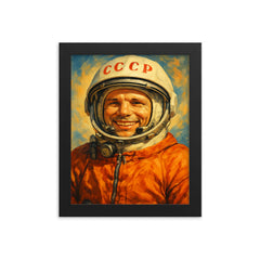 Yuri Gagarin smiling in cosmonaut orange framed print on a plain backdrop in size 8"x10".