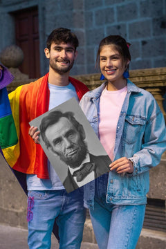 Smiling young man and woman holding an Abraham Lincoln poster print.