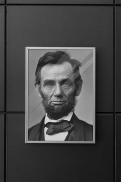 Poster case containing an Abraham Lincoln poster print mounted on a modern wall.