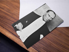 Close-up photo of a Mustafa Kemal Ataturk print lying on a wooden table.