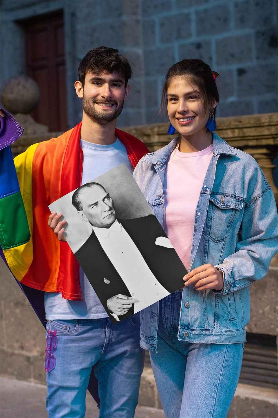 Smiling young man and woman holding a Mustafa Kemal Ataturk print.