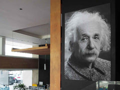 Einstein poster displayed on a wall in a coffee shop.