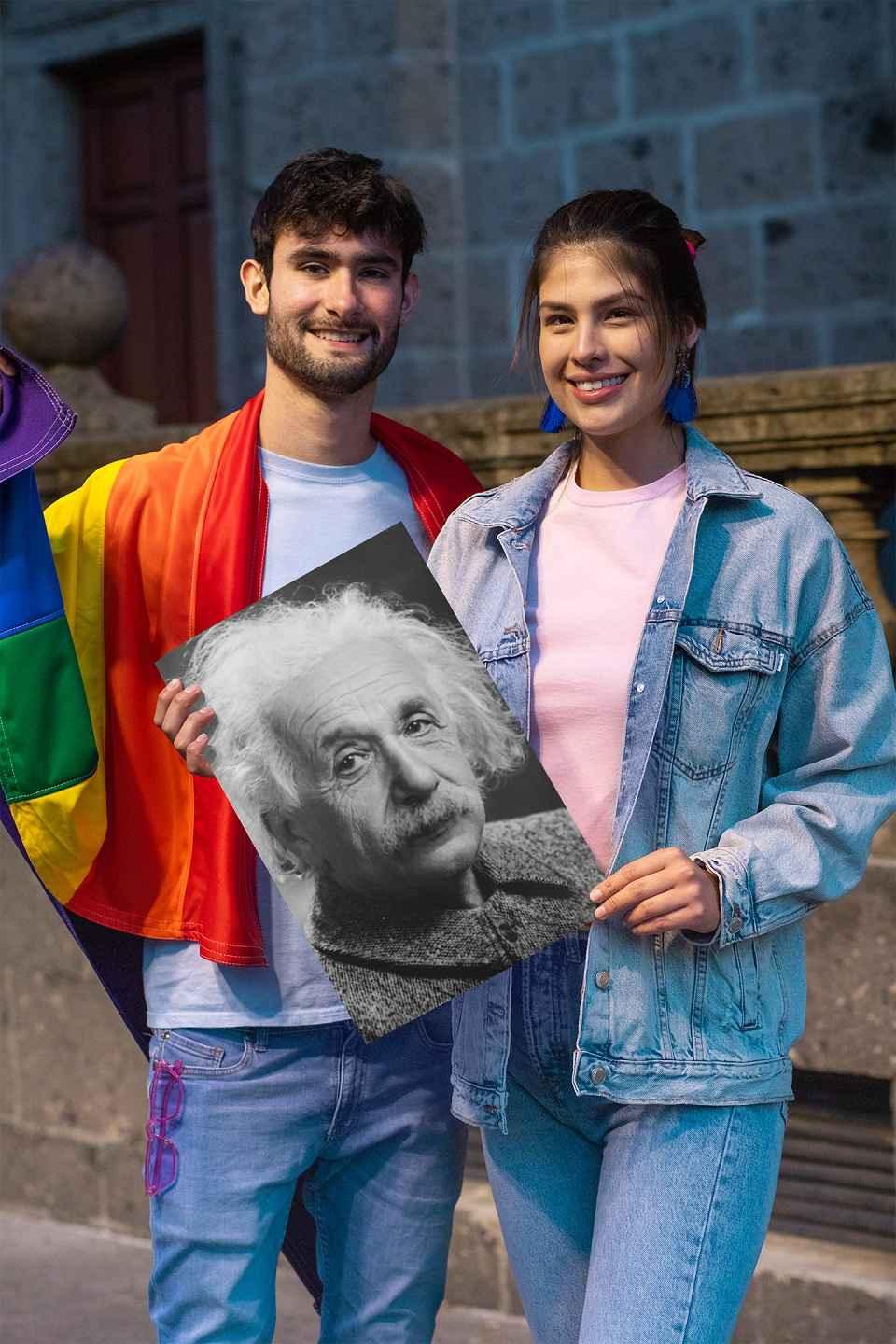 Smiling young man and woman holding an Einstein poster.