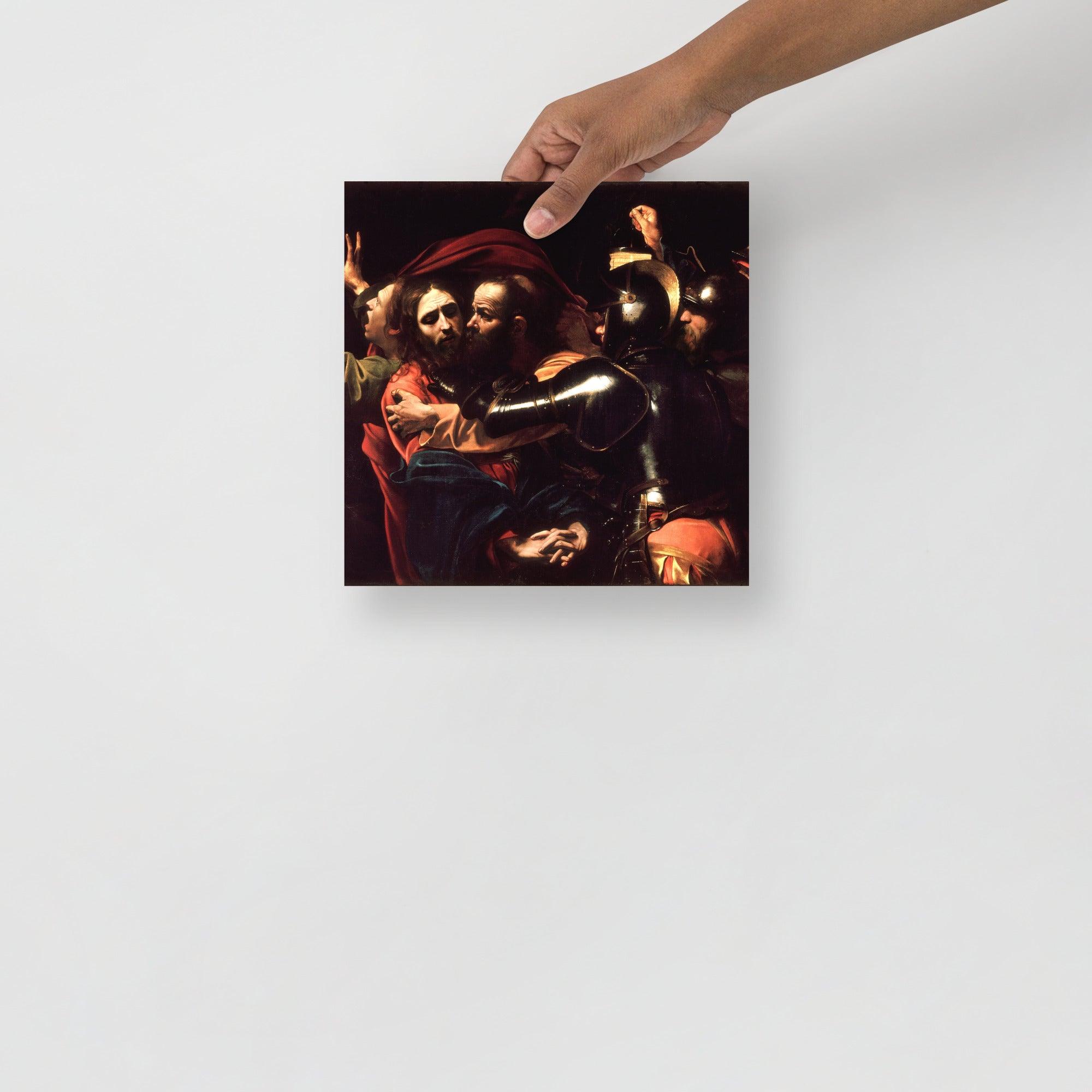 The Taking of Christ by Caravaggio poster on a plain backdrop in size 10x10”.