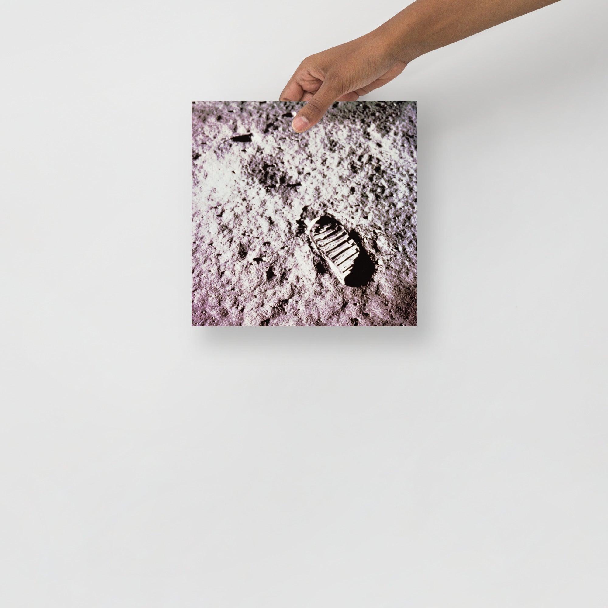 A Footprint on the Moon Apollo 11 poster on a plain backdrop in size 10x10”.