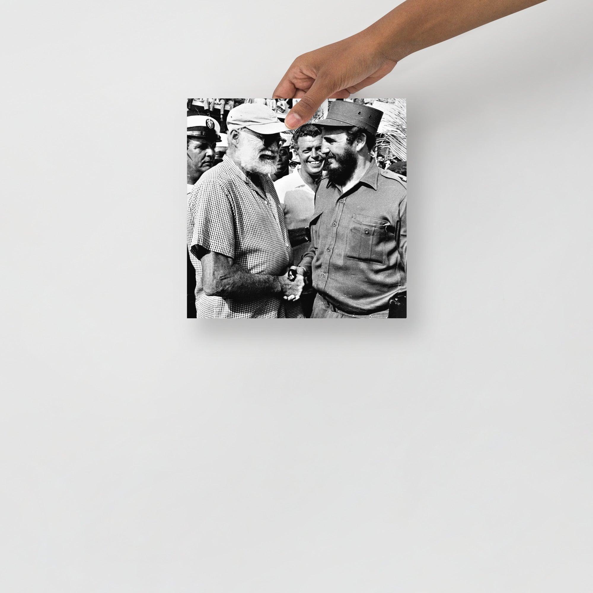 An Ernest Hemingway with Fidel Castro poster on a plain backdrop in size 10x10”.