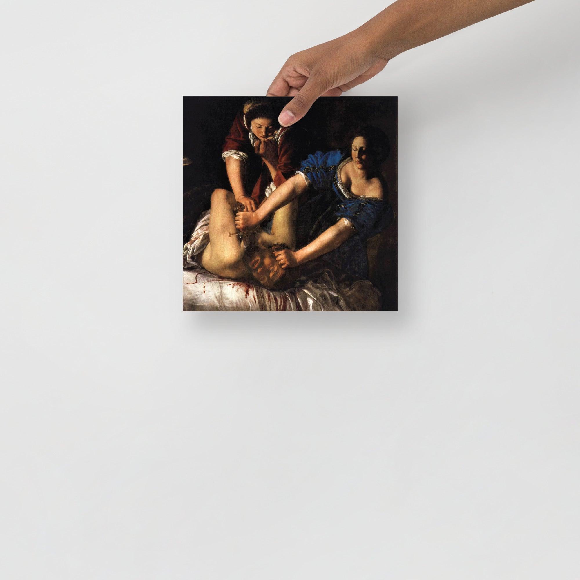 A Judith beheading Holofernes by Artemisia Gentileschi poster on a plain backdrop in size 10x10”.