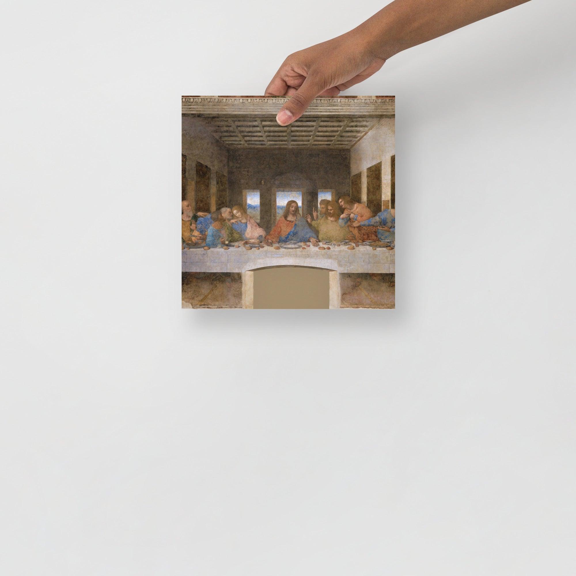 The Last Supper by Leonardo Da Vinci poster on a plain backdrop in size 10x10”.