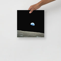 An Earthrise Apollo 8 poster on a plain backdrop in size 12x12”.