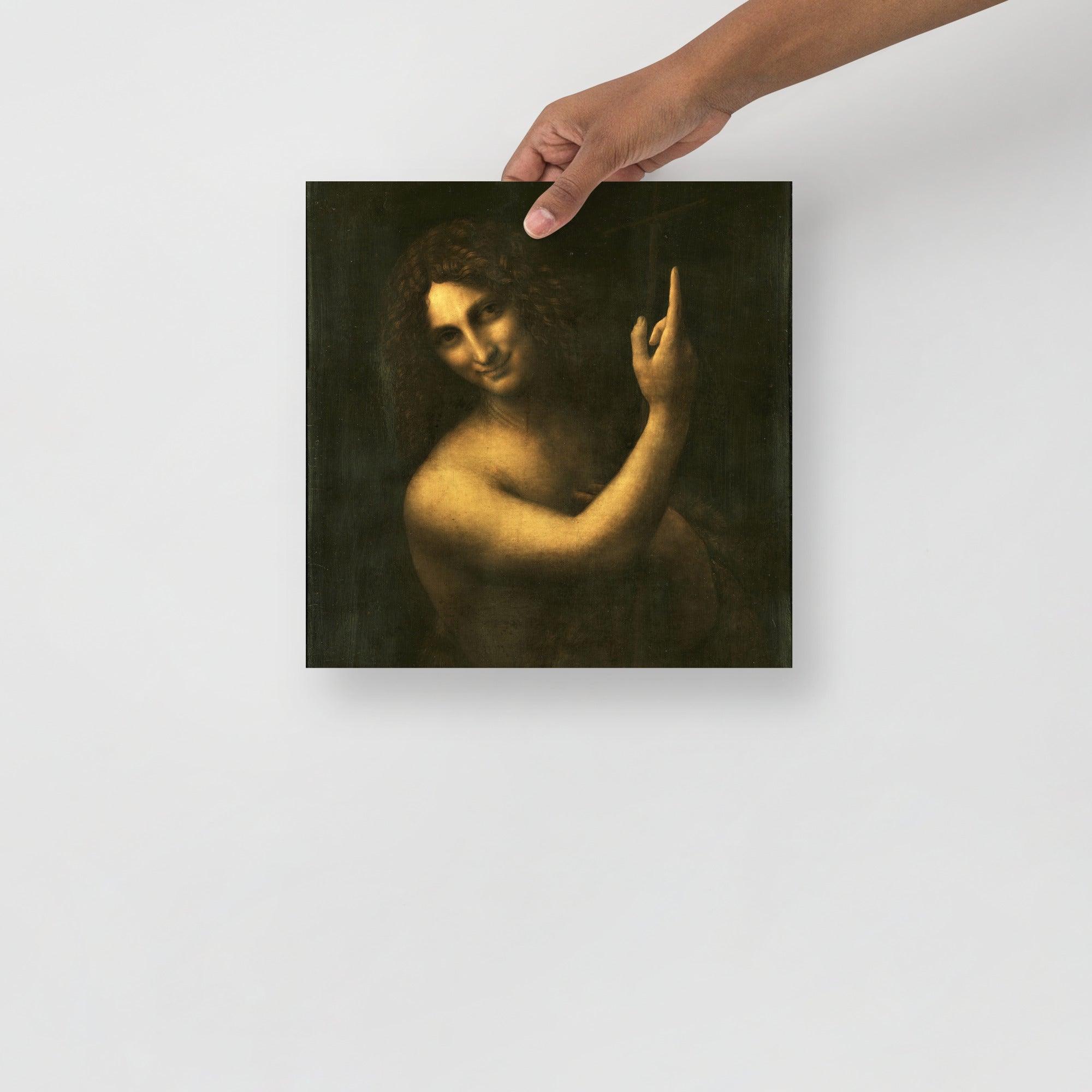 A Saint John the Baptist by Leonardo da Vinci poster on a plain backdrop in size 12x12”.