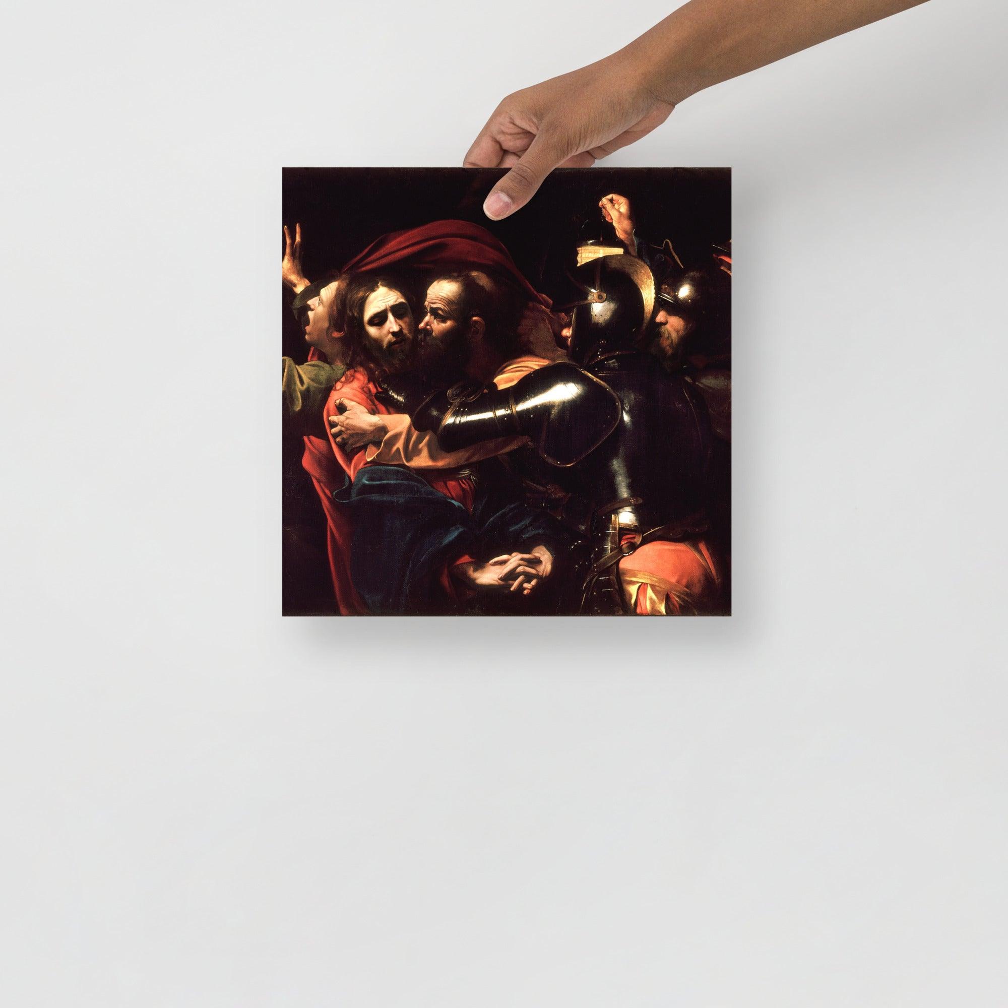 The Taking of Christ by Caravaggio poster on a plain backdrop in size 12x12”.