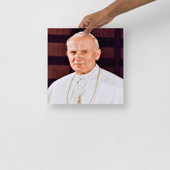 A Pope John Paul II poster on a plain backdrop in size 12x12”.