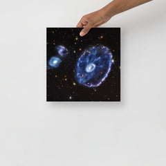 A Cartwheel Galaxy by James Webb Space Telescope poster on a plain backdrop in size 12x12”.