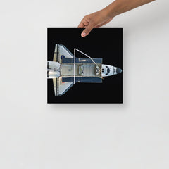 A Space Shuttle Atlantis poster on a plain backdrop in size 12x12”.