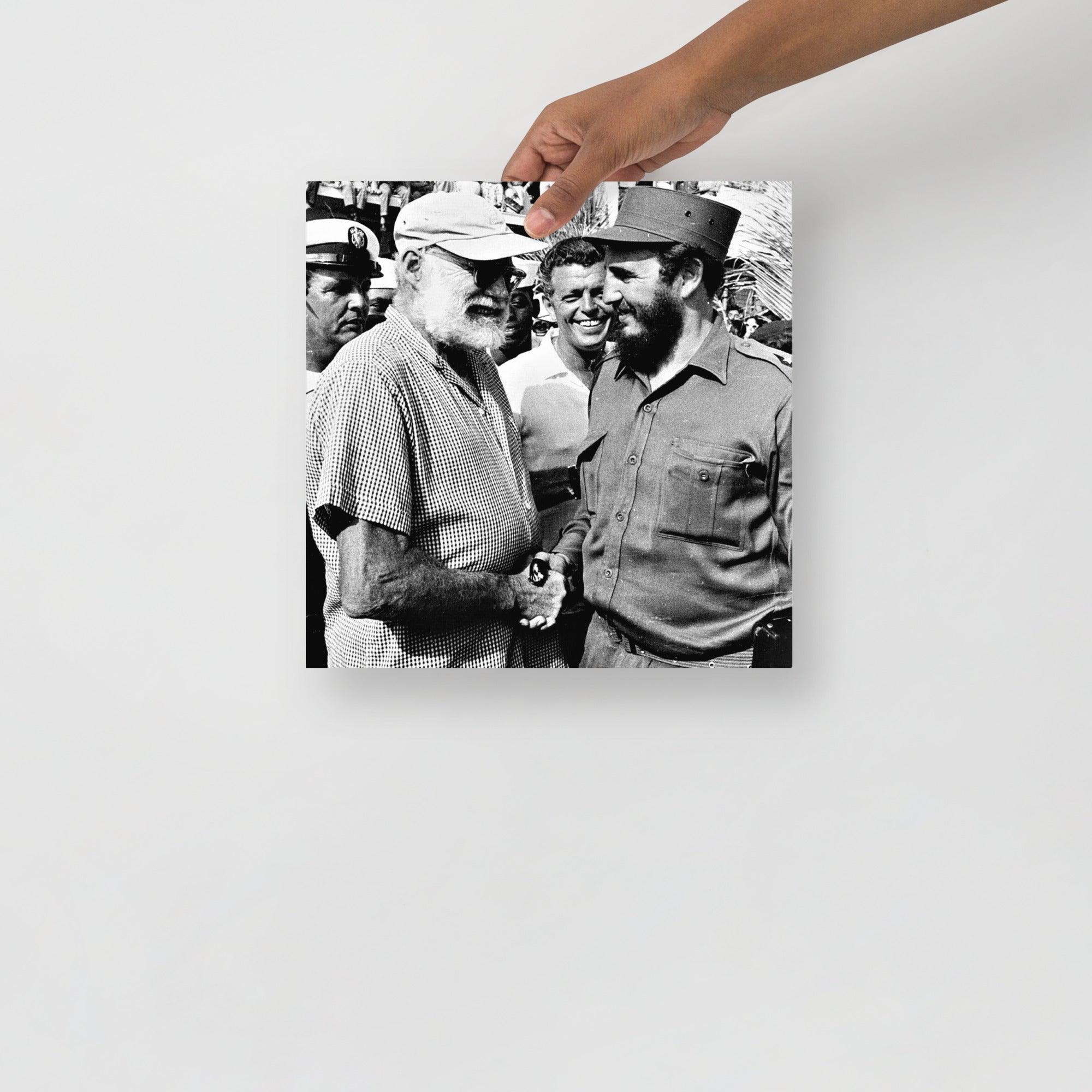 An Ernest Hemingway with Fidel Castro poster on a plain backdrop in size 12x12”.