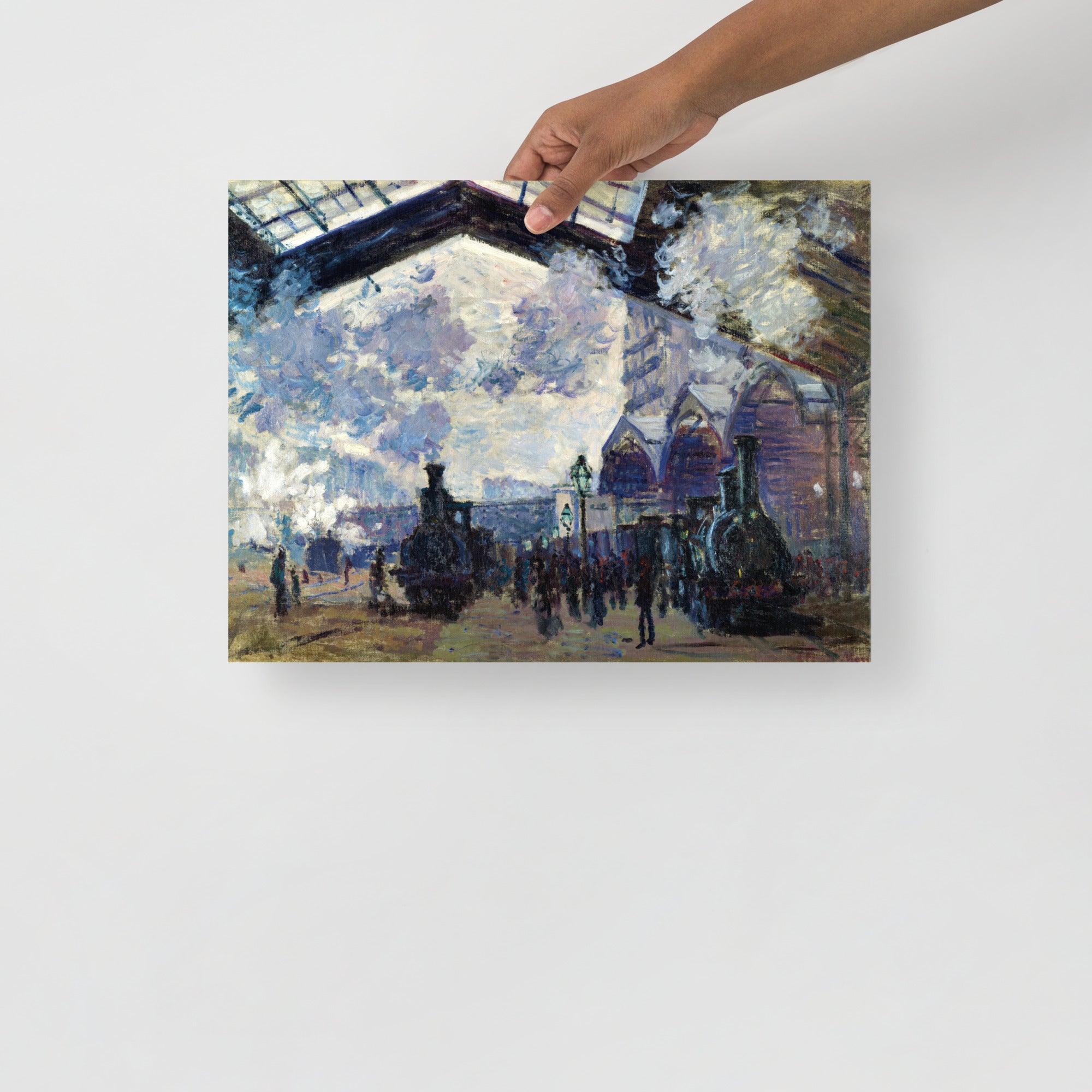 The Gare St-Lazare by Claude Monet  poster on a plain backdrop in size 12x16”.