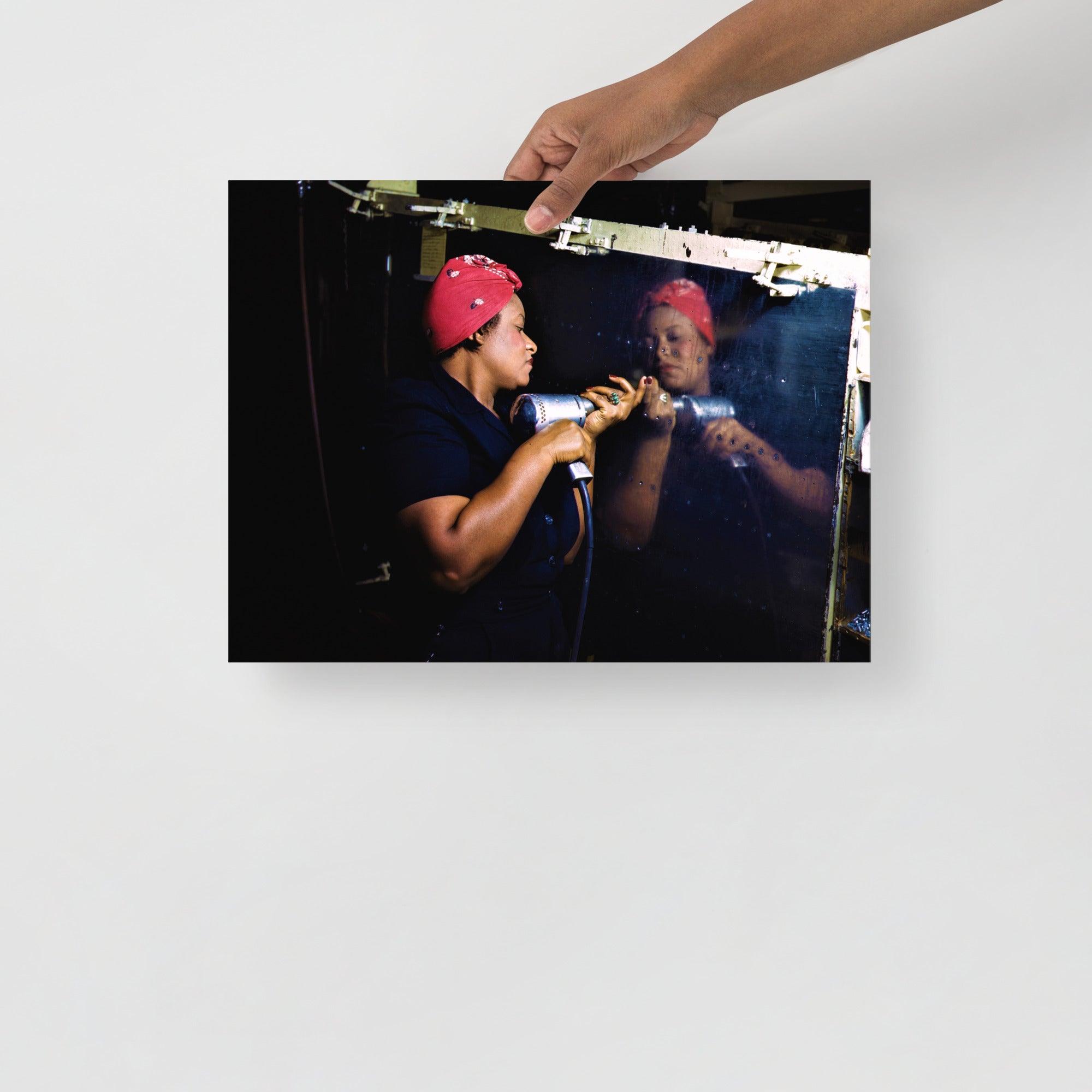 A Rosie the Riveter poster on a plain backdrop in size 12x16”.