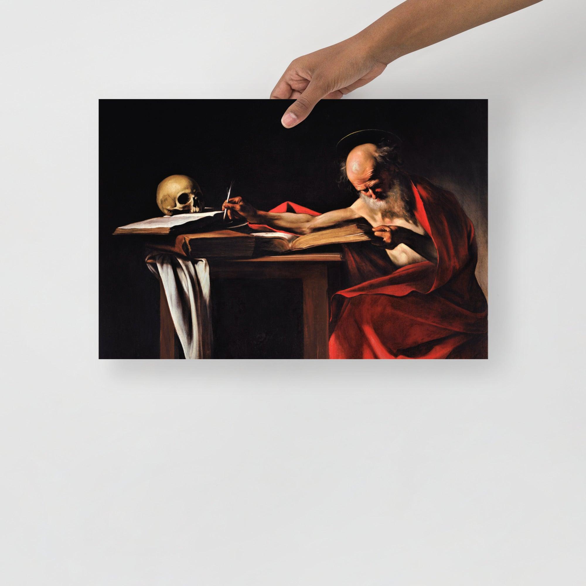 A Saint Jerome Writing by Caravaggio poster on a plain backdrop in size 12x18”.