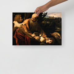 A Sacrifice of Isaac by Caravaggio poster on a plain backdrop in size 12x18”.