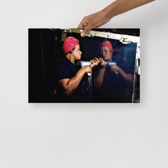 A Rosie the Riveter poster on a plain backdrop in size 12x18”.