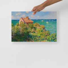 A Fisherman's Cottage at Varengeville by Claude Monet poster on a plain backdrop in size 12x18”.